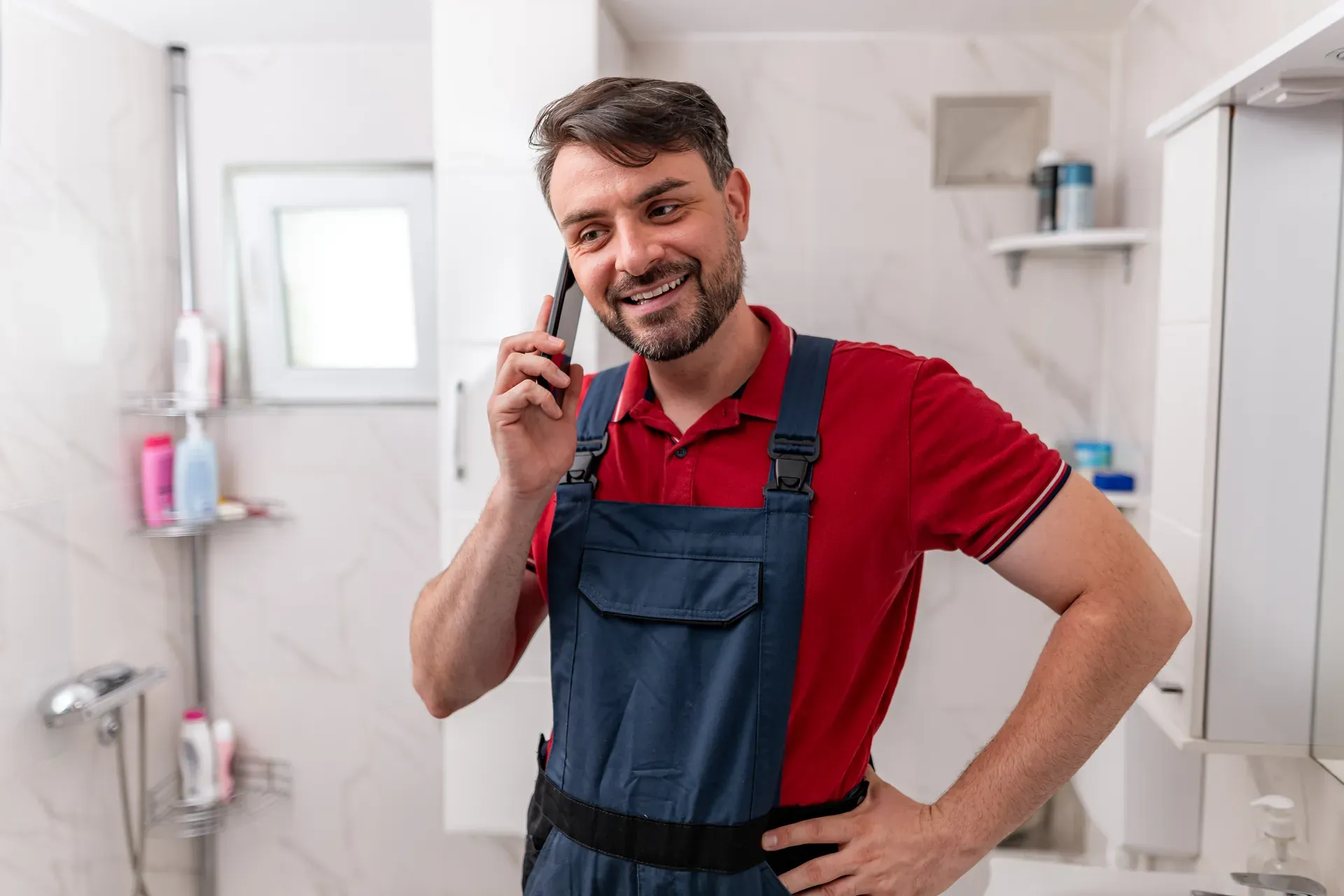 Jake Hartwell on the phone in a customer's bathroom
